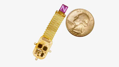 The thin, flexible, wireless device sits next to a quarter for scale. Device emits complex patterns of light (shown here as an 'N') to transmit information directly to the brain.