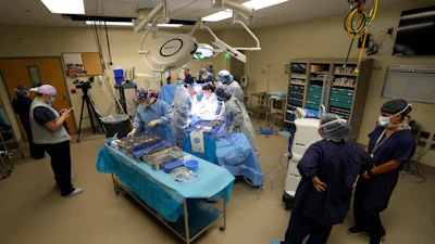 An organ recovery team works to remove the liver and kidneys from a donor June 15, 2023, in Jackson, Tenn.