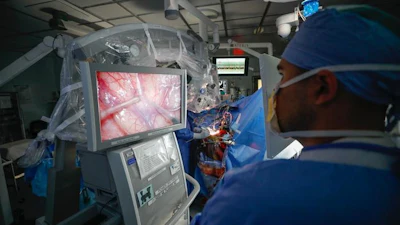 Taylor Furst, MD, observes a brain mapping procedure in progress at the University of Rochester’s Strong Memorial Hospital.