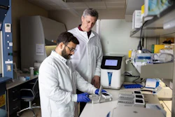 Dr. Chander Negi prepares samples using the PhysioMimix LC12 liver-on-a-chip system as Dr. Ivan Rusyn looks on in their Texas A&M research laboratory.