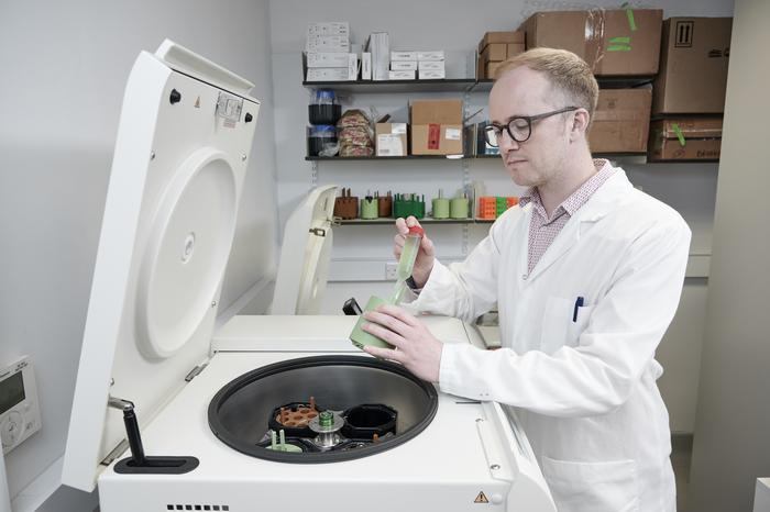 Professor Stephen Wallace harvesting engineered bacteria for analysis.
