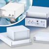 Collection of white laboratory instruments and spectrometry devices displayed against blue background