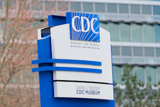 CDC logo and David J. Sencer CDC Museum sign on blue and white directional monument outside building