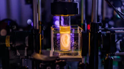 Holographic projection of a human ear model on a sample vial.