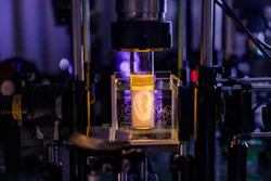 Holographic projection of a human ear model on a sample vial.
