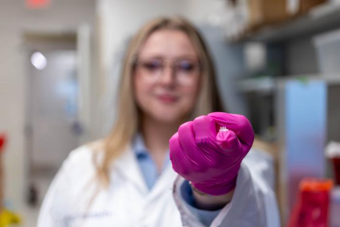 Elizabeth Kelleyholding a cytokine-secreting patch.