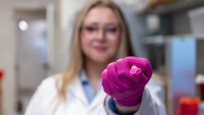 Elizabeth Kelleyholding a cytokine-secreting patch.