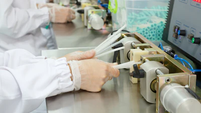A worker testing hydrophilic urinary catheters.