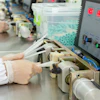 A worker testing hydrophilic urinary catheters.