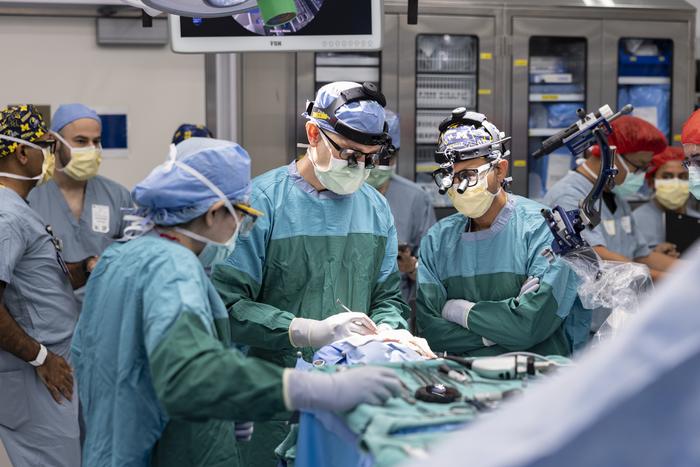 Dr. Matthew Willsey (middle) secures the Connexus BCI after implantation.
