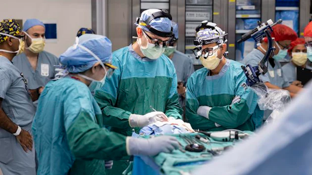Dr. Matthew Willsey (middle) secures the Connexus BCI after implantation.