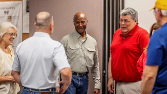 Retired Major General Mike Talley (center) met last month in Chillicothe with U.S. Paper Mill executives, including Michelle Tolliver (left) and Bob Stanley (right).