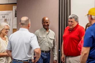 Retired Major General Mike Talley (center) met last month in Chillicothe with U.S. Paper Mill executives, including Michelle Tolliver (left) and Bob Stanley (right).