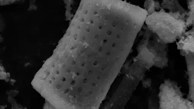 Cylindrical microparticles with a catalytic coating release tiny oxygen bubbles that coalesce and burst to disrupt stubborn biofilms on contaminated surgical instruments and infected wounds.