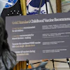 A sign about childhood vaccines is pictured as President Donald Trump speaks during a meeting to sign an executive order, Monday, Aug. 10, 2026, in the Oval Office of the White House in Washington.