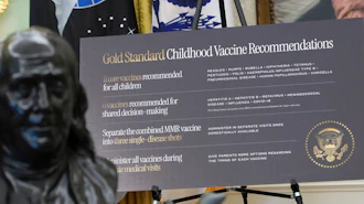 A sign about childhood vaccines is pictured as President Donald Trump speaks during a meeting to sign an executive order, Monday, Aug. 10, 2026, in the Oval Office of the White House in Washington.