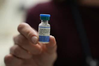 Dr. Jessica Early holds a vial of the combination measles, mumps and rubella vaccine at Prisma Health Pediatrics in Greer, S.C., March 18, 2026.