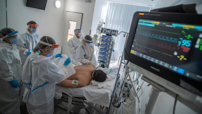 Doctors and nurses wearing protective gears attend a patient on ventilator at the intensive care unit of Szent Laszlo Hospital treating COVID-19 patients during the pandemic of new coronavirus COVID-19 in Budapest, Hungary, on Dec. 13, 2021.