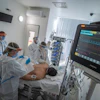Doctors and nurses wearing protective gears attend a patient on ventilator at the intensive care unit of Szent Laszlo Hospital treating COVID-19 patients during the pandemic of new coronavirus COVID-19 in Budapest, Hungary, on Dec. 13, 2021.
