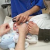 A premature baby is examined for the eye disease Retinopathy of prematurity (ROP).