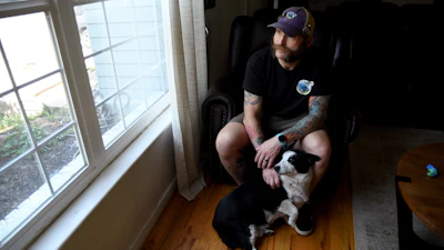 Joe Shearer, who was recently diagnosed with traumatic brain injuries from fighting in Iraq, poses for a portrait in his home in Colorado Springs, Colo., Wednesday, Aug. 5, 2026.