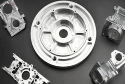 Precision-machined engine and mechanical components arranged symmetrically on dark background