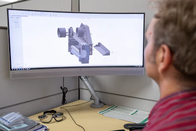 Engineer utilizes design software to develop and refine component tooling.