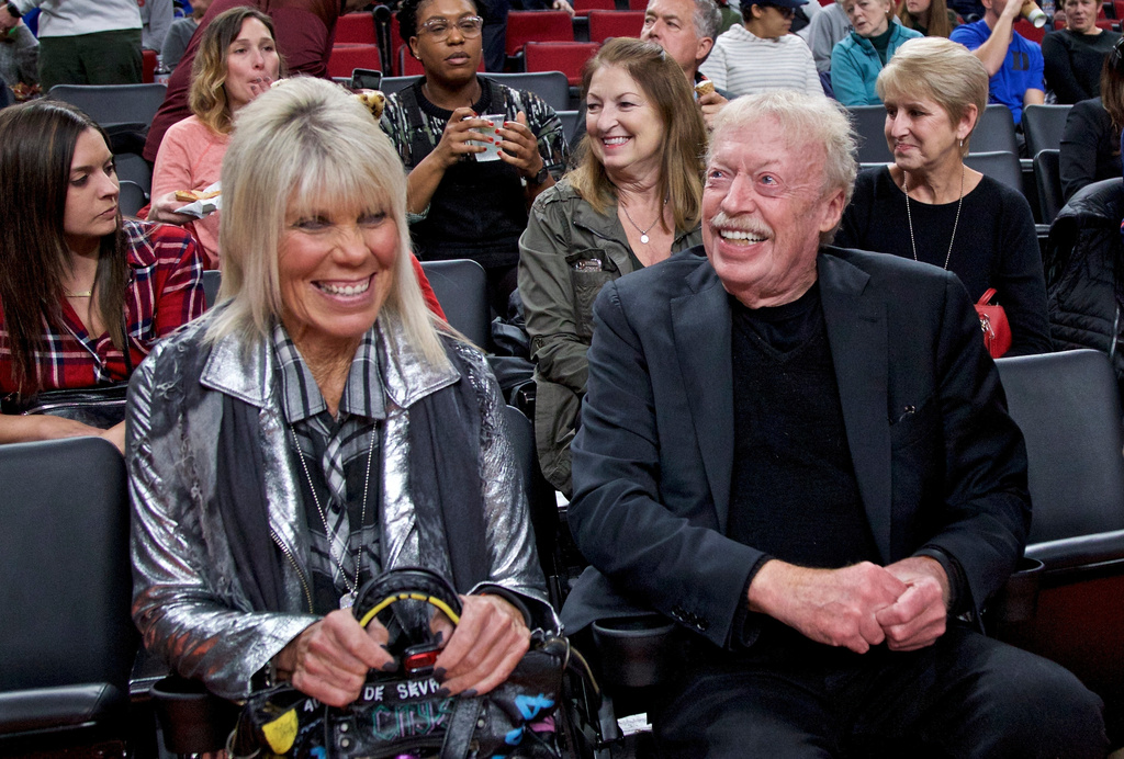 Phil Knight, right, and Penny Knight, watch the first half of an NCAA college basketball game in the Phil Knight Invitational tournament in Portland, Ore., on Nov. 26, 2017.