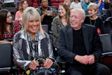 Phil Knight, right, and Penny Knight, watch the first half of an NCAA college basketball game in the Phil Knight Invitational tournament in Portland, Ore., on Nov. 26, 2017.