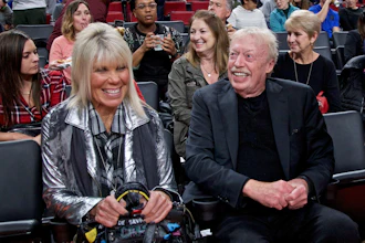 Phil Knight, right, and Penny Knight, watch the first half of an NCAA college basketball game in the Phil Knight Invitational tournament in Portland, Ore., on Nov. 26, 2017.