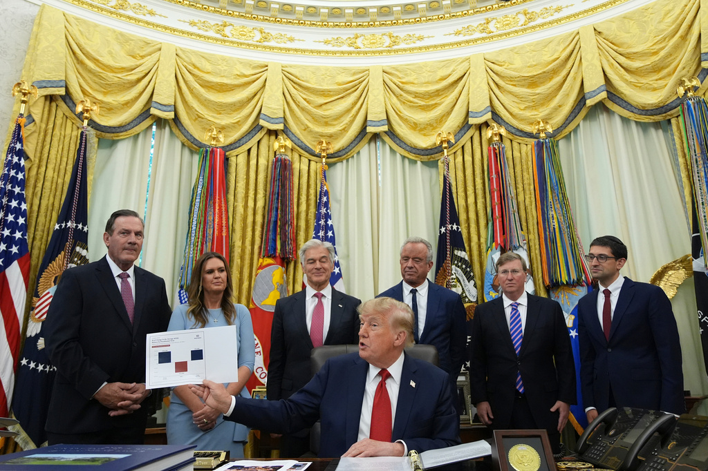 President Donald Trump speaks as South Dakota Gov. Larry Rhoden, from left, Arkansas Gov. Sarah Huckabee Sanders, Mehmet Oz, administrator of the Centers for Medicare & Medicaid Services, Health and Human Services Secretary Robert F. Kennedy Jr., Mississippi Gov. Tate Reeves and Abe Sutton, director of the Center for Medicare and Medicaid Innovation, listen during an event about healthcare in the Oval Office of the White House, Friday Sept. 18, 2026, in Washington.