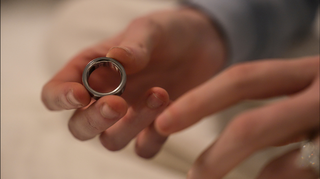 Silver metal ring held in open palm during a tender moment