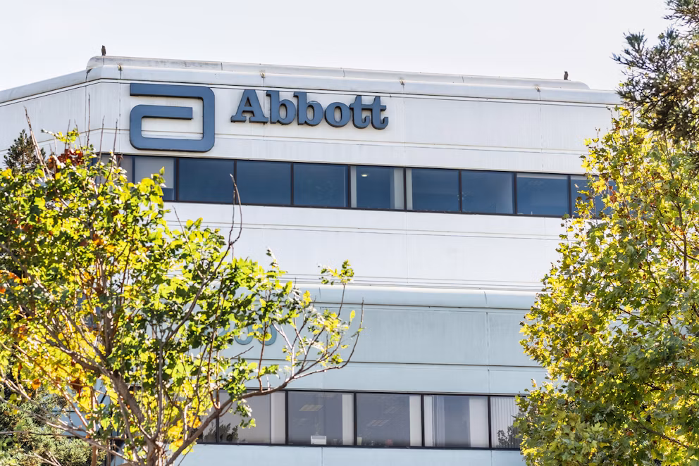 Abbott corporate headquarters building with blue logo signage and surrounding green landscaping