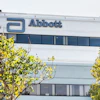 Abbott corporate headquarters building with blue logo signage and surrounding green landscaping