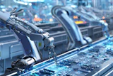 Robotic arms assembling circuit boards in a high-tech manufacturing facility with blue lighting