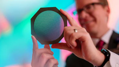 Radiation oncology medical physicist Dr. Michael Grams holds a device called a tungsten collimator that divides a conventional radiation beam into submillimeter-wide beamlets.
