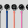 Five Eko handheld devices with colored handles displaying different functions: temperature, recording, analyzing, documentation, and learning modes.