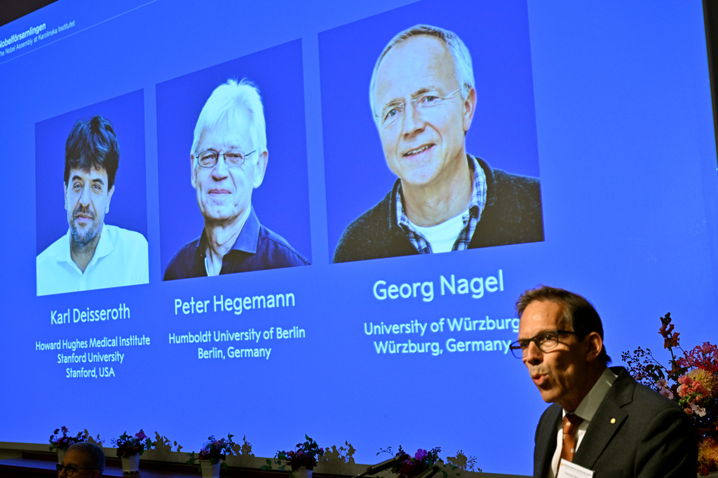 Nobel Prize announcement display showing three laureates: Karl Deisseroth, Peter Hegemann, and Georg Nagel with their institutional affiliations