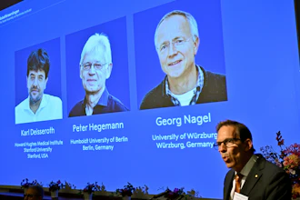 Nobel Prize announcement display showing three laureates: Karl Deisseroth, Peter Hegemann, and Georg Nagel with their institutional affiliations