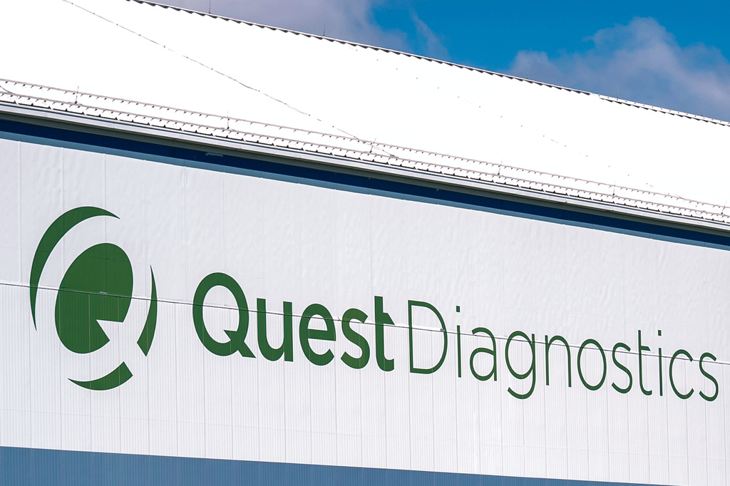 Quest Diagnostics building signage with green logo and text on white exterior wall
