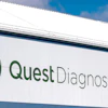 Quest Diagnostics building signage with green logo and text on white exterior wall