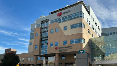 IHC Health multi-story medical facility building with modern architecture, glass windows, and desert landscaping under blue sky