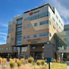 IHC Health multi-story medical facility building with modern architecture, glass windows, and desert landscaping under blue sky