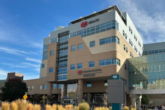 IHC Health multi-story medical facility building with modern architecture, glass windows, and desert landscaping under blue sky