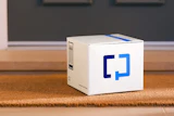 White Zapier product box with blue logo on wooden floor in modern interior