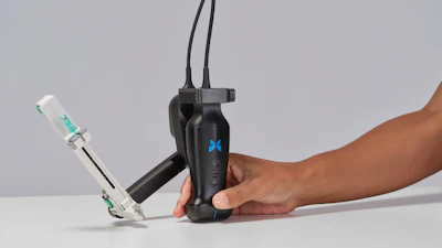 Person holding black handheld gimbal stabilizer with blue X logo and attached smartphone mount