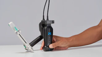 Person holding black handheld gimbal stabilizer with blue X logo and attached smartphone mount