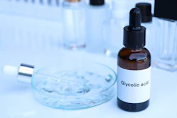 Glycolic acid bottle with dropper in laboratory setting with petri dish and test tubes