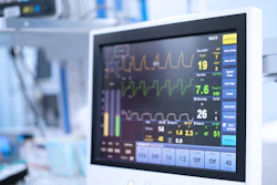 Hospital patient monitor displaying vital signs including heart rate, oxygen saturation, and waveform tracings in clinical setting