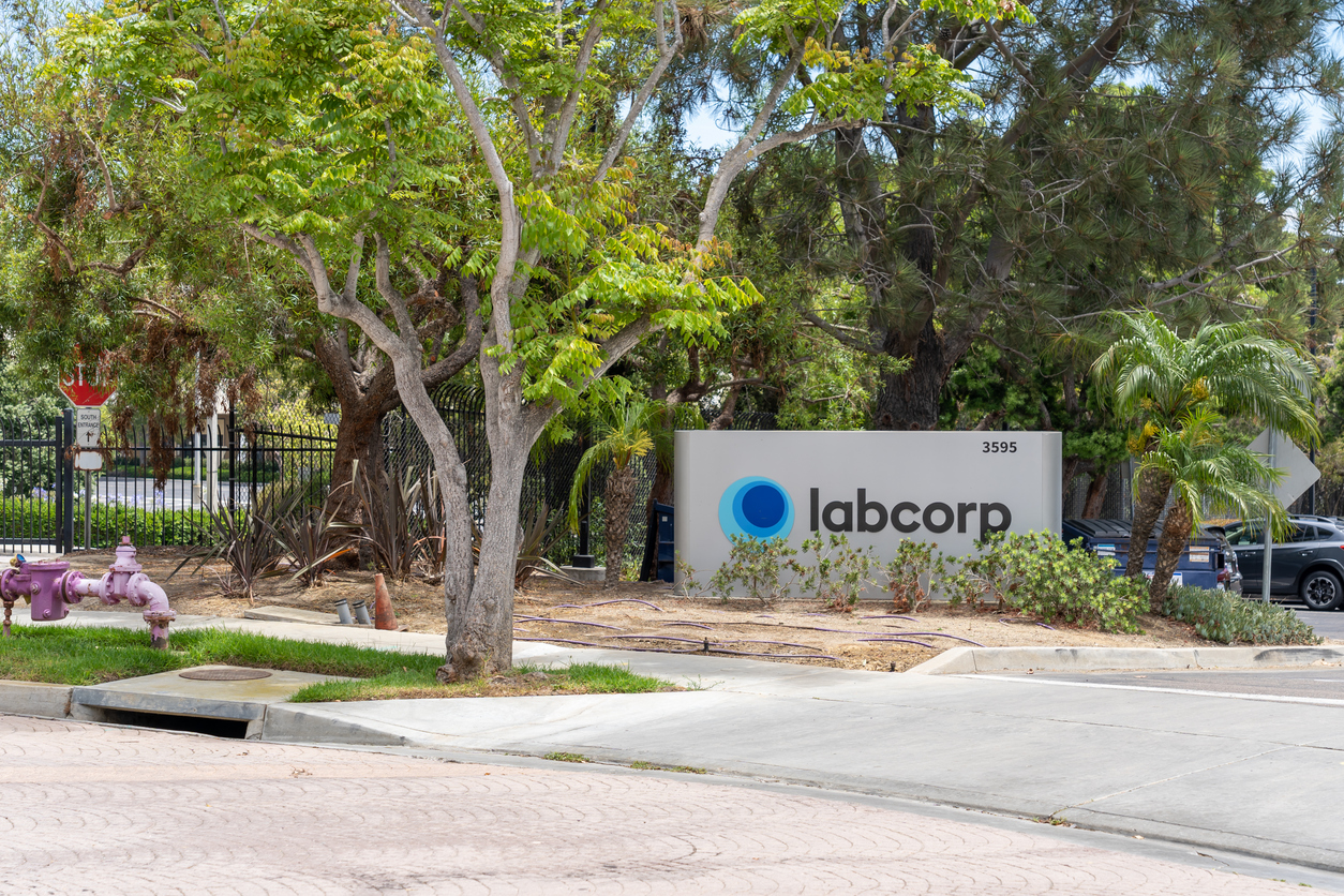 Labcorp corporate sign at building entrance with mature trees and landscaping